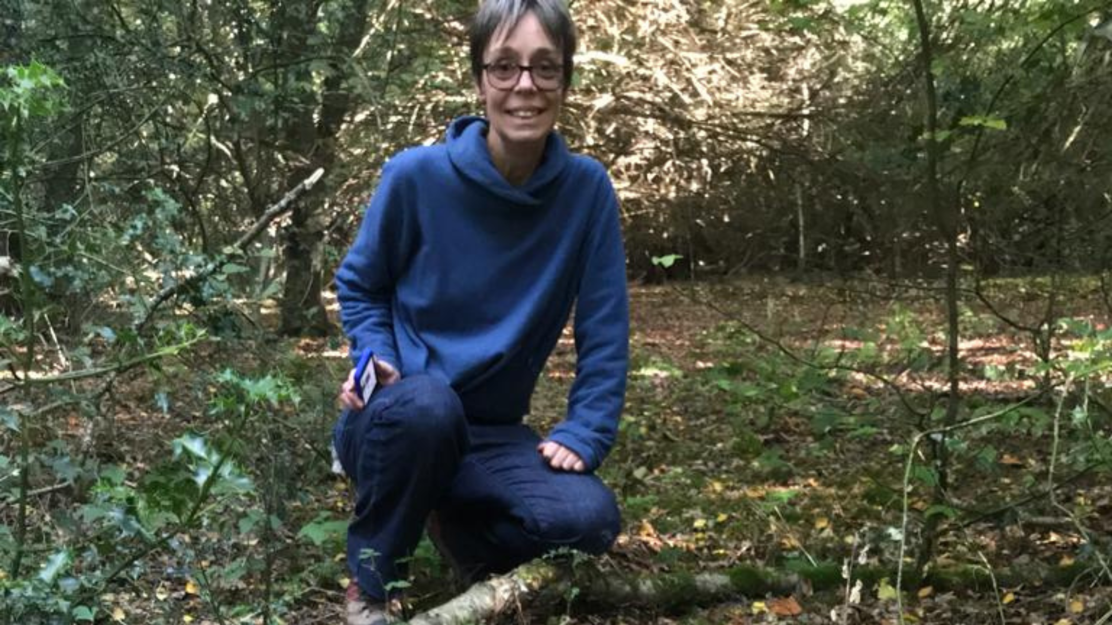 Image of Jacquetta Fewster, Coordination Officer at the Surrey Climate Commission in a field of mushrooms
