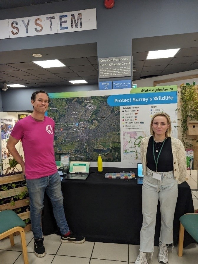 Image of Ben McCallan and Niamh from the Surrey County Council Climate Change team running an engagement session on the URBAOs project, asking residents to make a pledge to do something to make their garden nature friendly.