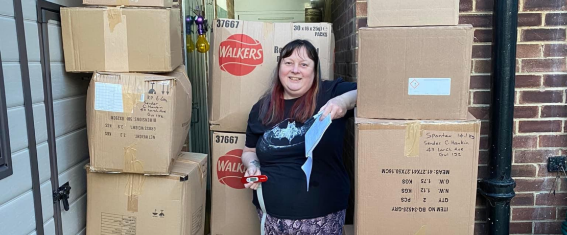 Image of Cheryl Hankin, who runs CTK Recycling Guildford, standing in her garage surrounded by boxes of recycling