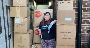 Image of Cheryl Hankin, who runs CTK Recycling Guildford, standing in her garage surrounded by boxes of recycling